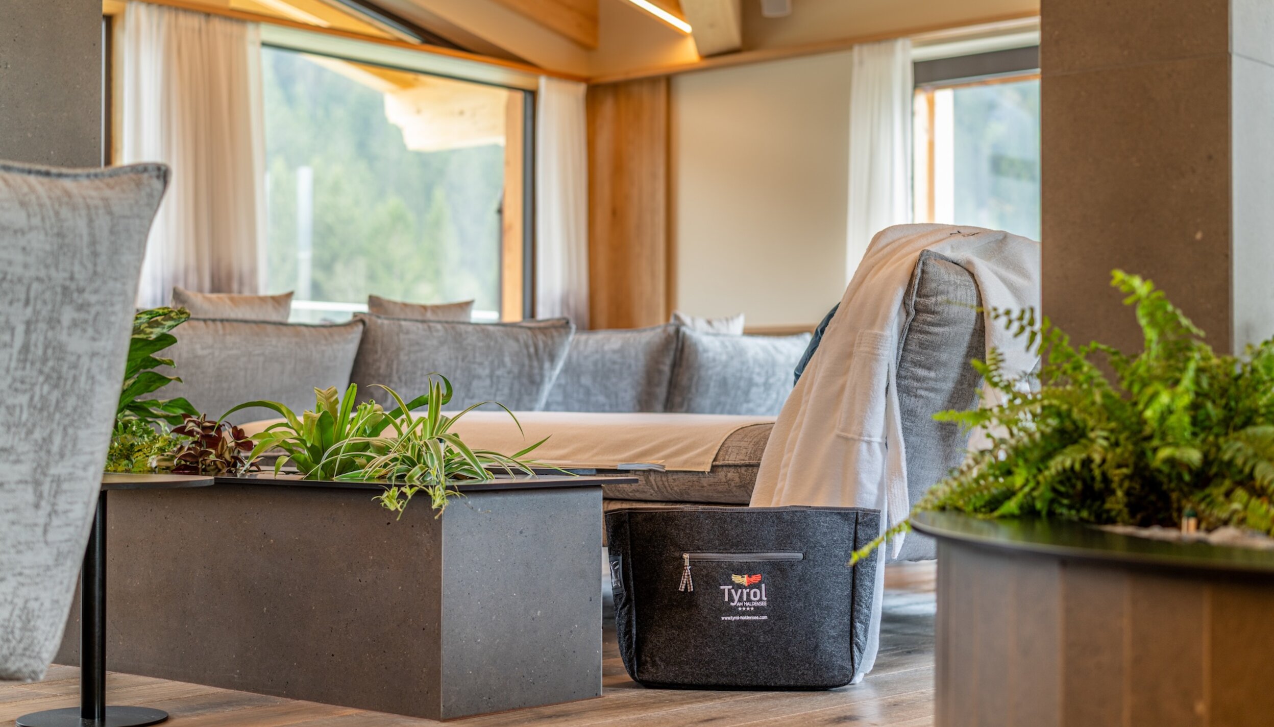 Hotel Tyrol Ruheraum mit Sofa, Tisch und Pflanzen
